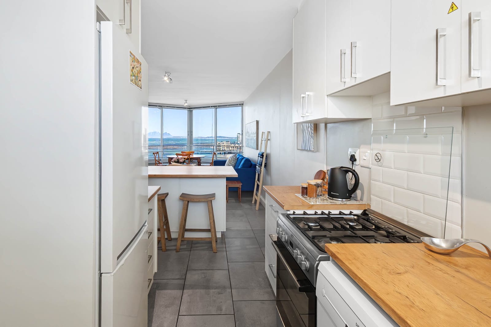 Kitchen opening toward the sea-facing living area